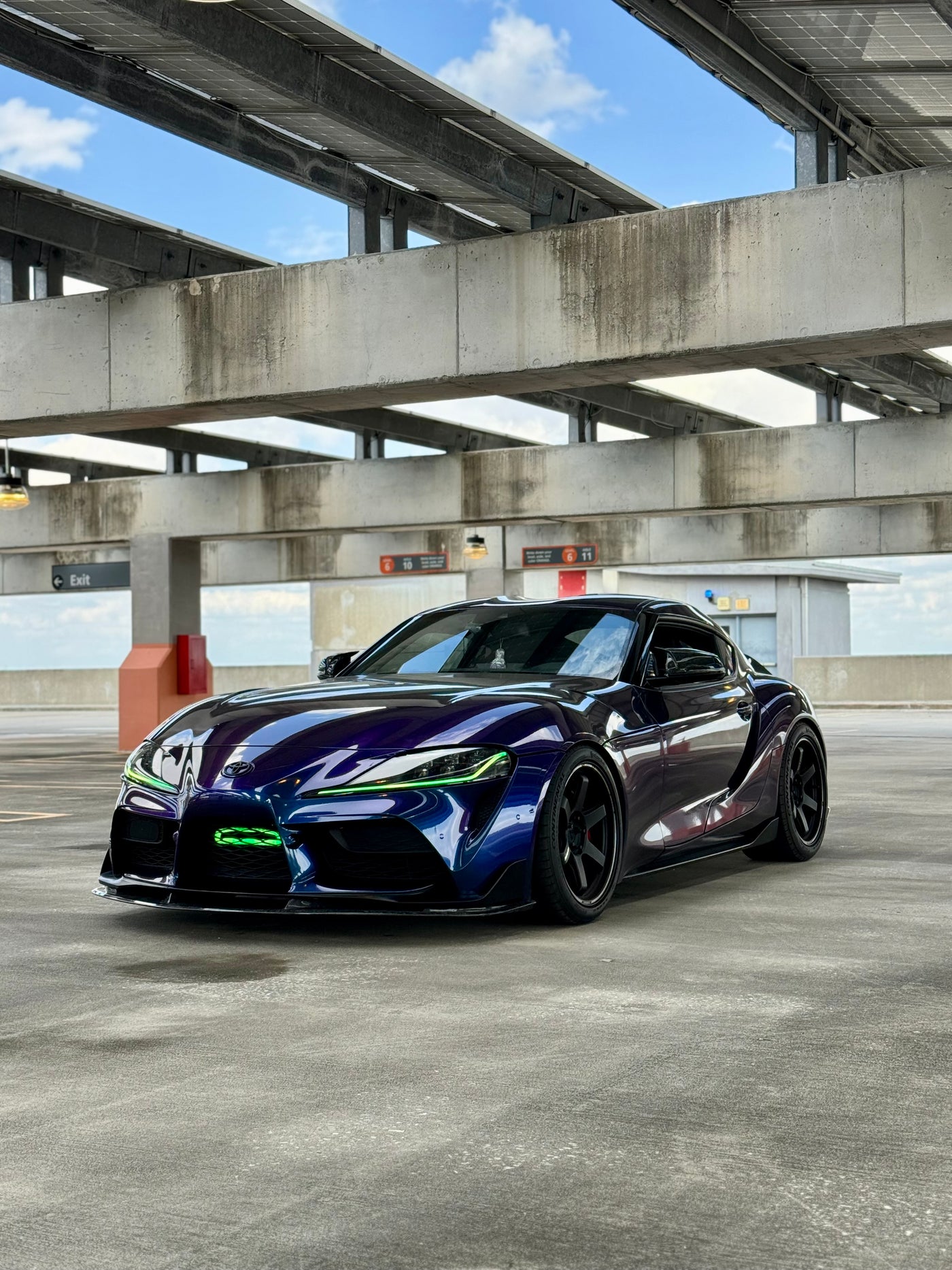Supra car on a concrete surface with a bridge in the background
